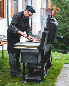 chef cooking in offset smoker