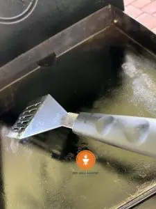 Scraping the griddle top