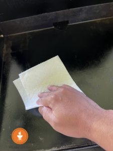 wiping the griddle clean